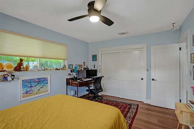 a bedroom with a bed and a window