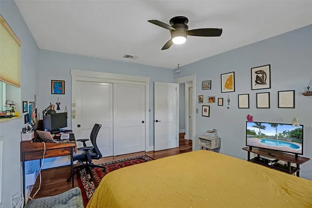 a bedroom with a bed a desk and chair