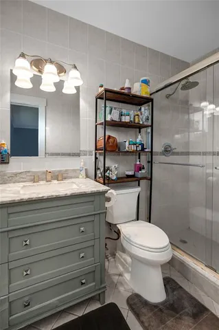 a bathroom with a toilet sink and shower