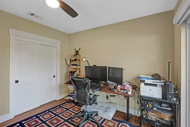 a view of a workspace with furniture and a window
