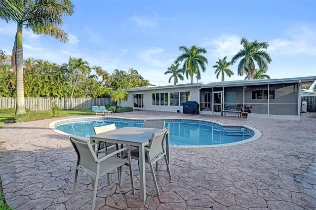 a view of a patio with a table and chairs