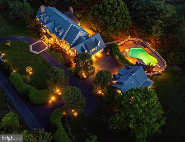 an aerial view of a house with outdoor space pool seating area and yard