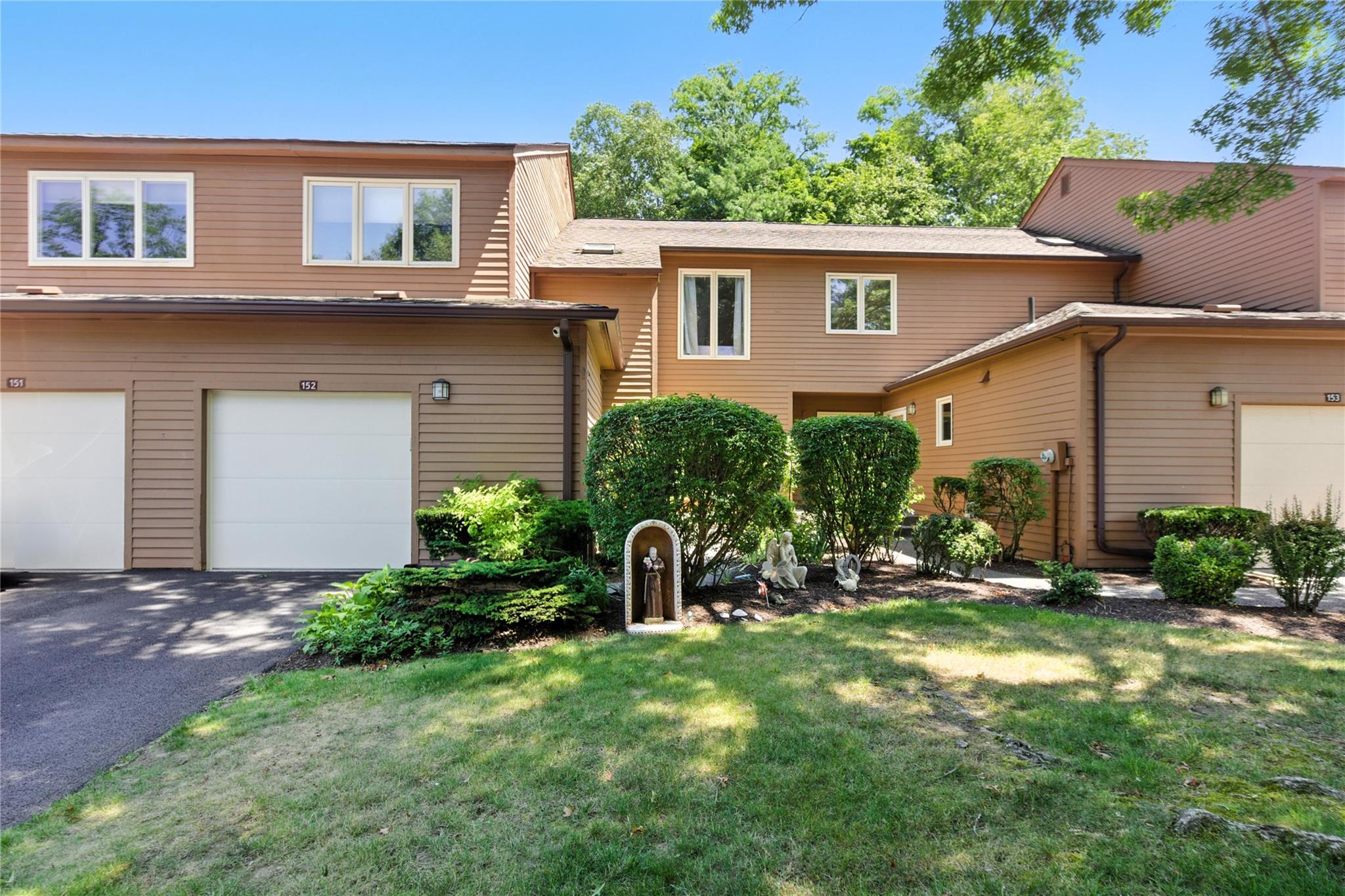 a front view of a house with garden