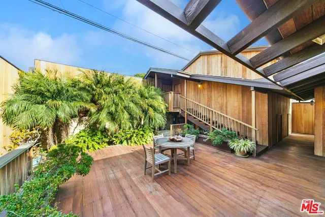 a balcony with furniture and a potted plant