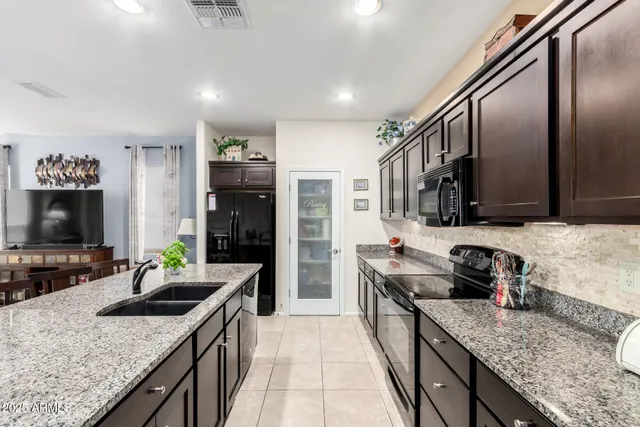 a kitchen with stainless steel appliances granite countertop a stove and a sink