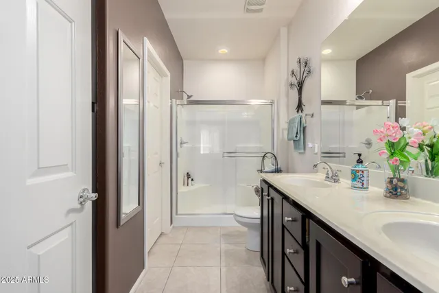 a en suite bathroom with a granite countertop a sink and a mirror