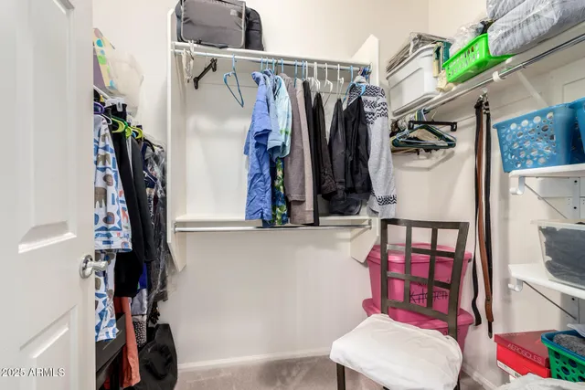 a bedroom with bed and a chandelier