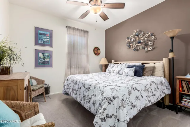 a bedroom with a bed dresser and a window