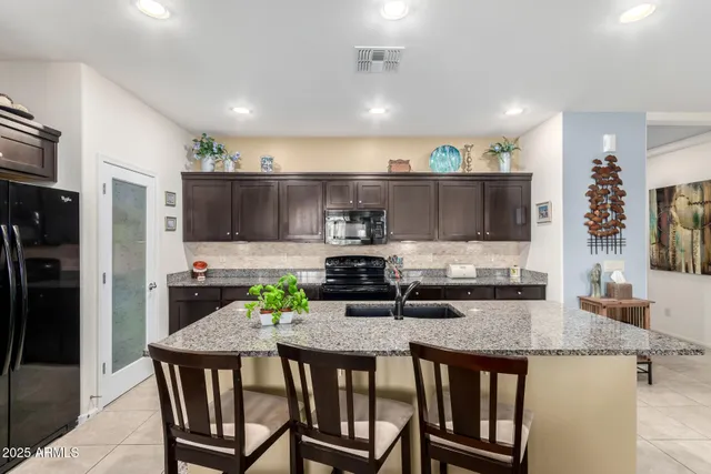 a kitchen with granite countertop a sink and cabinets