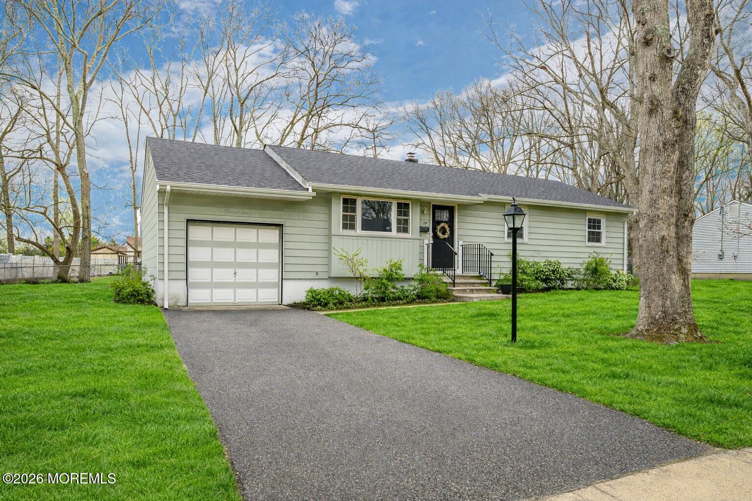 a front view of house with yard and green space