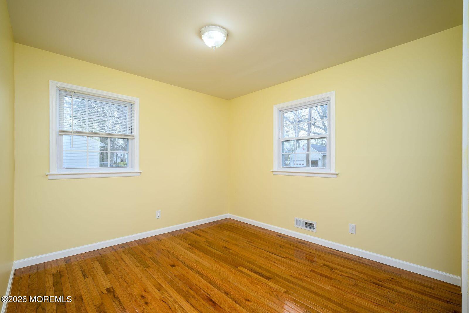 19 Princeton Drive Howell, NJ 07731 - Photo 14 of 36 a view of an empty room with wooden floor and a window