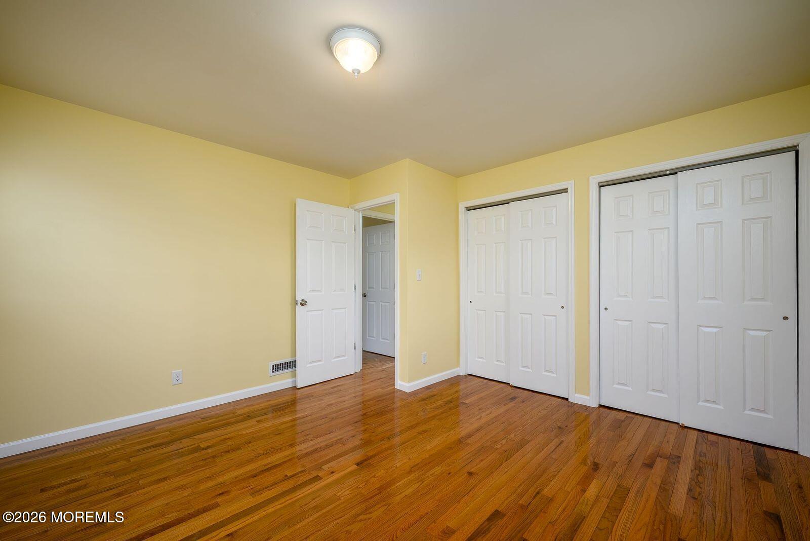 19 Princeton Drive Howell, NJ 07731 - Photo 18 of 36 a view of an empty room with wooden floor