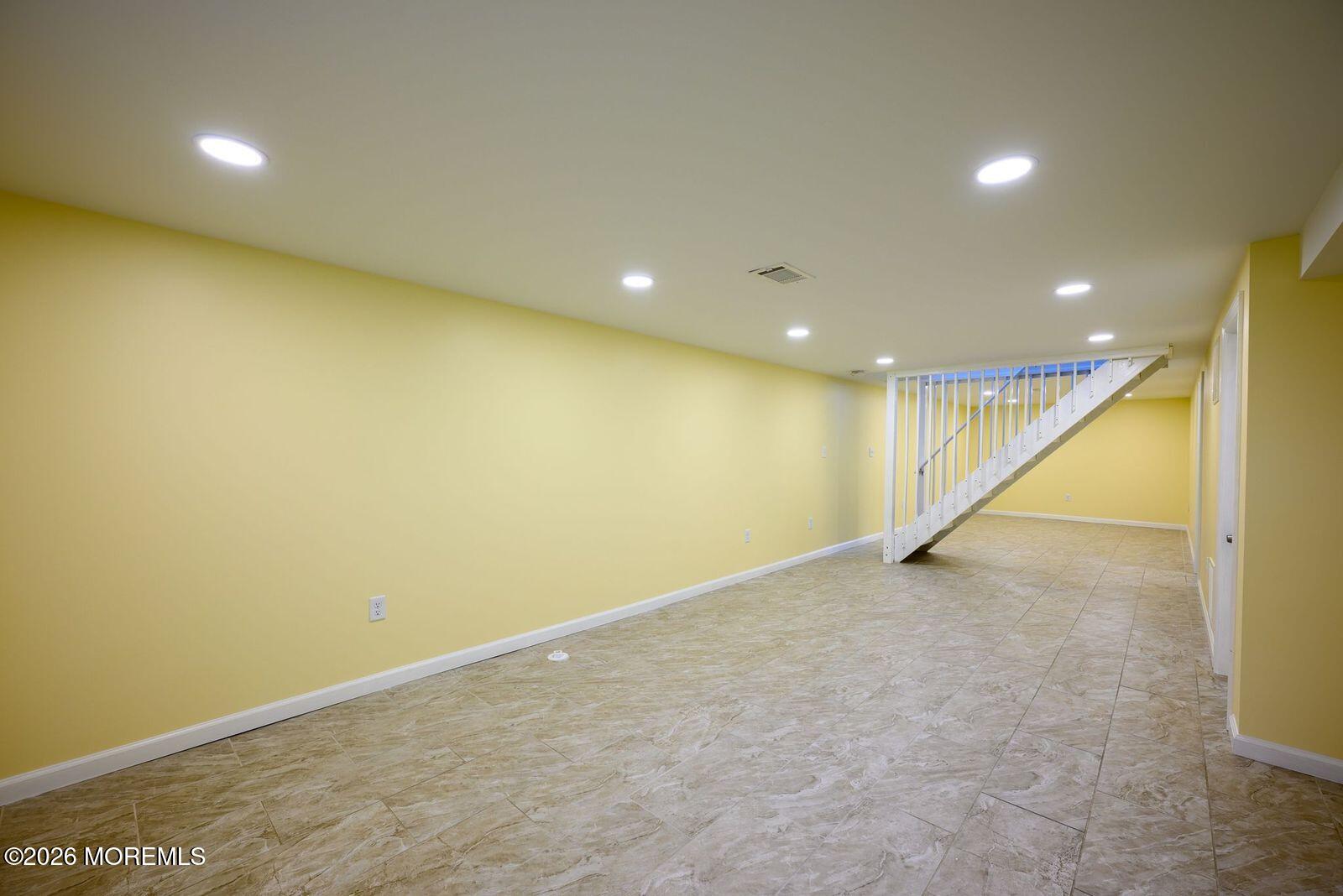 19 Princeton Drive Howell, NJ 07731 - Photo 21 of 36 an empty room with wooden floor and windows