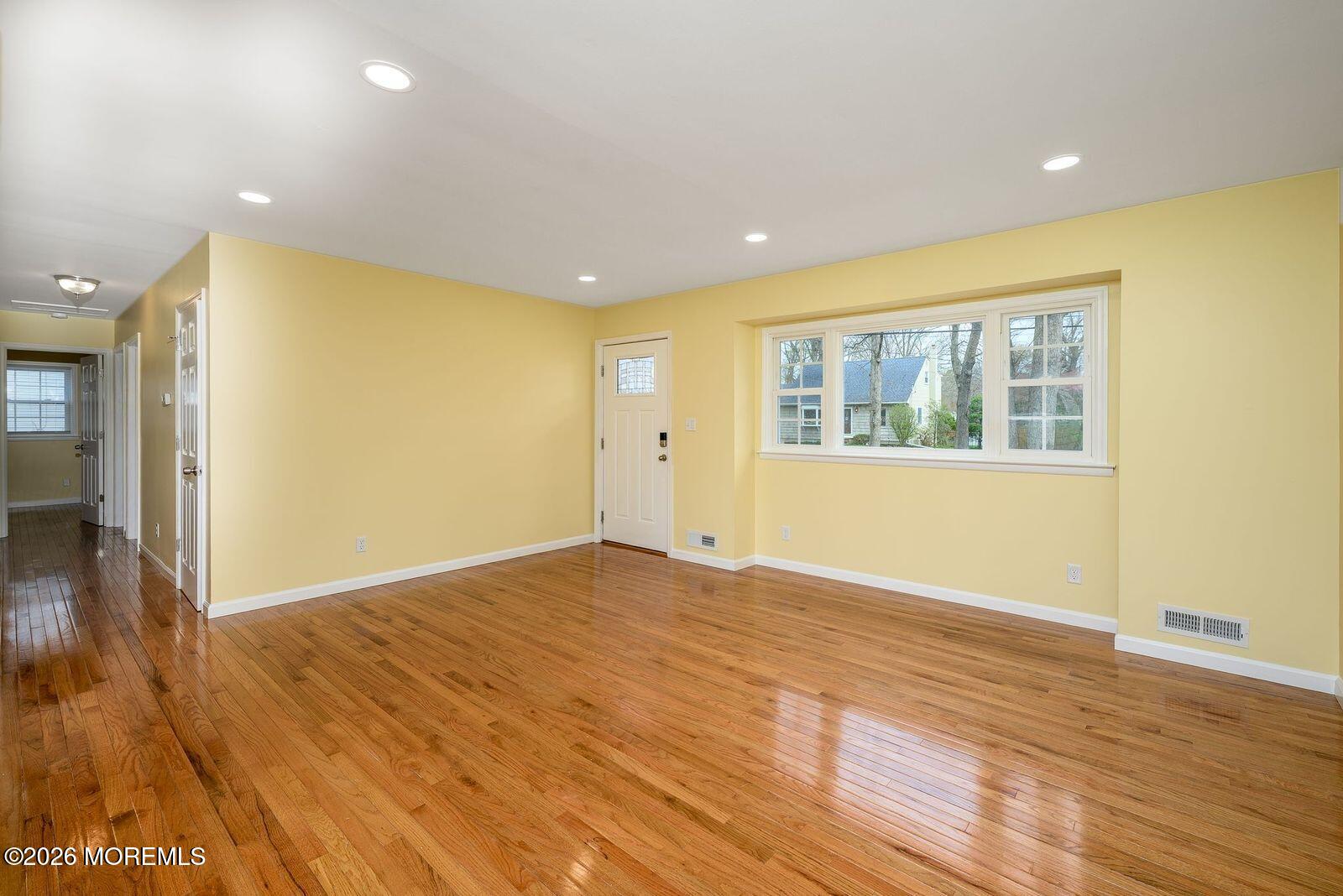 19 Princeton Drive Howell, NJ 07731 - Photo 3 of 36 a view of an empty room with wooden floor and a window