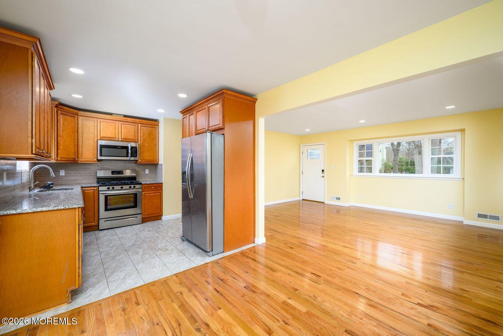 19 Princeton Drive Howell, NJ 07731 - Photo 6 of 36 a kitchen with stainless steel appliances granite countertop a refrigerator and a stove top oven