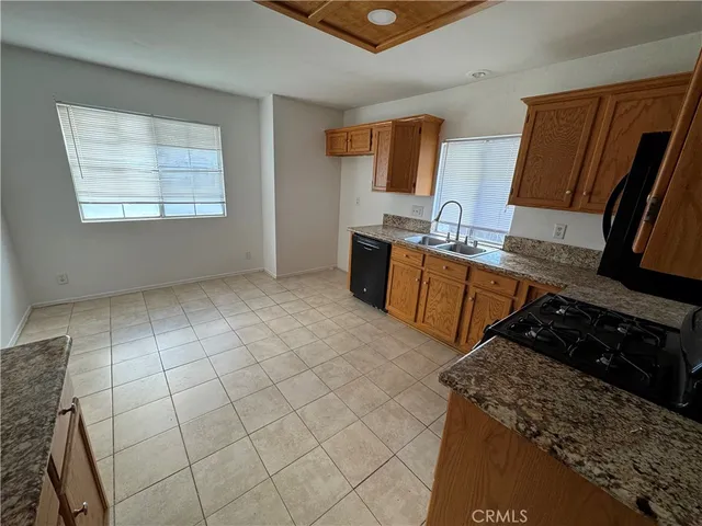 a kitchen with stainless steel appliances a stove a sink and a microwave