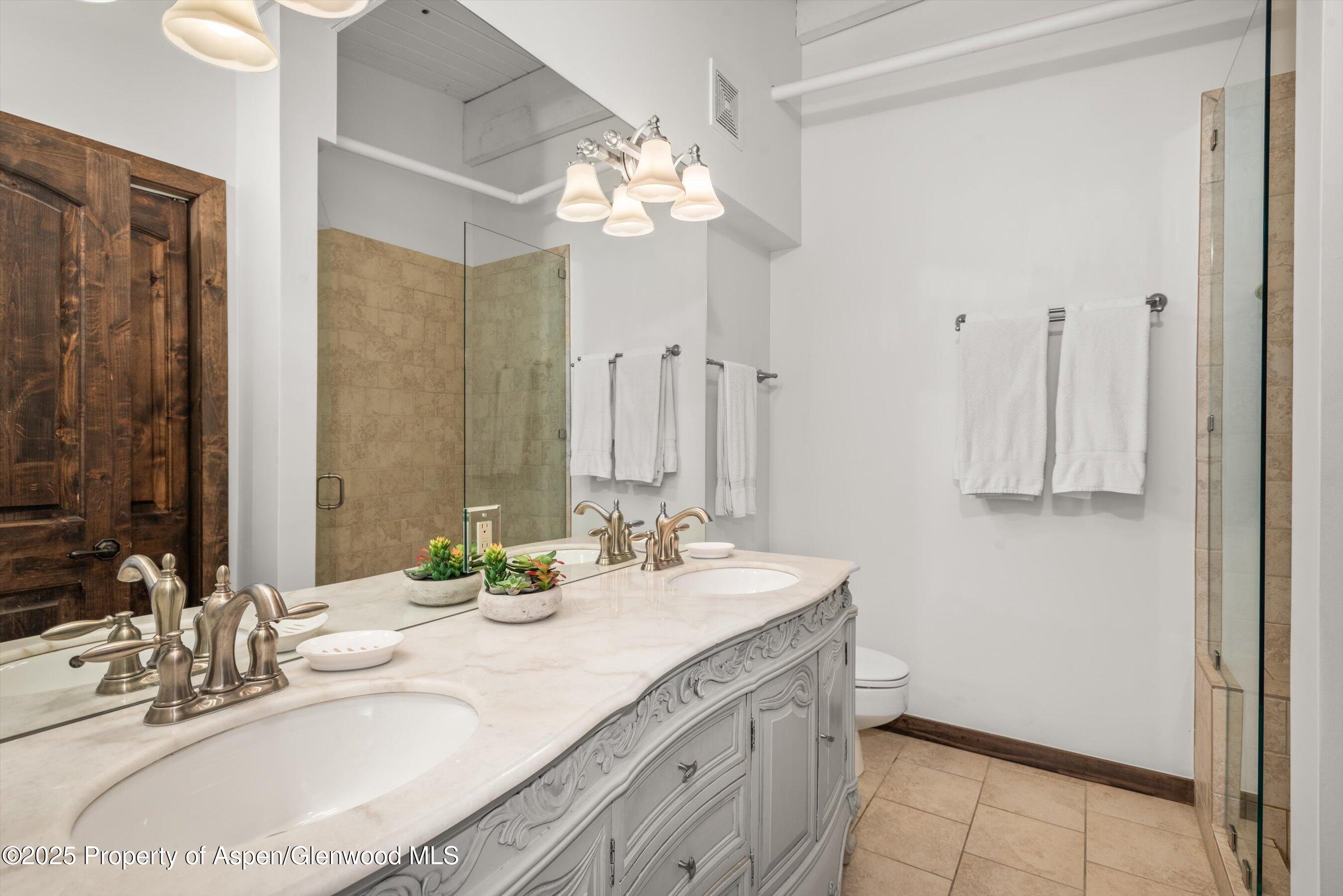 1039 East Cooper Avenue, Unit 36B Aspen, CO 81611 - Photo 11 of 15 a bathroom with a double vanity sink and a mirror