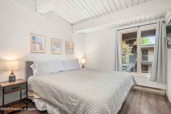 a bedroom with a large bed and a window