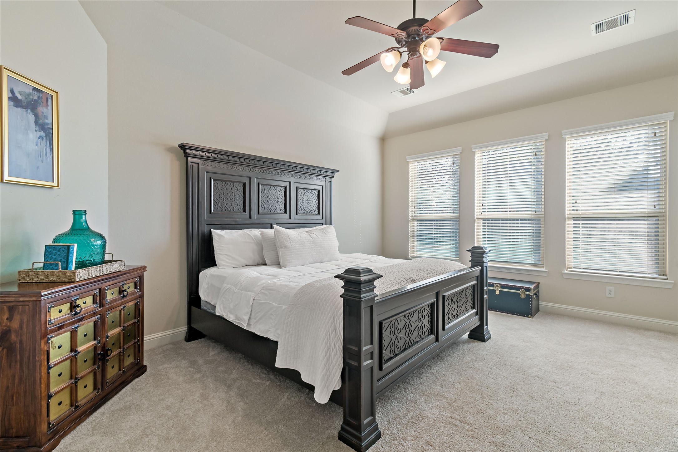 8126 Spreadwing Street Conroe, TX 77385 - Photo 20 of 30 Primary bedroom with three windows for natural light.