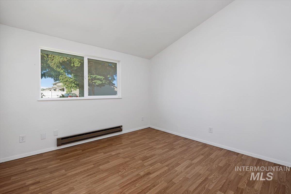 259 Pheasant Road, Unit 84 Twin Falls, ID 83301 - Photo 14 of 25 Bright interior space featuring wood-finish flooring, white walls, and a large window