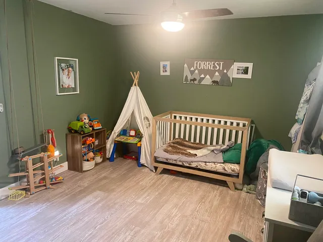 a view of a room with wooden floor and furniture