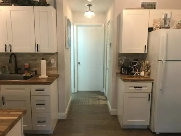 a view of a backyard with table and chairs under an umbrella