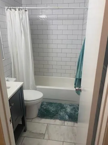 a bathroom with a toilet and shower