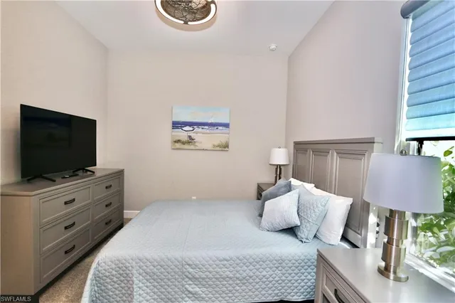 a bedroom with furniture and a flat screen tv