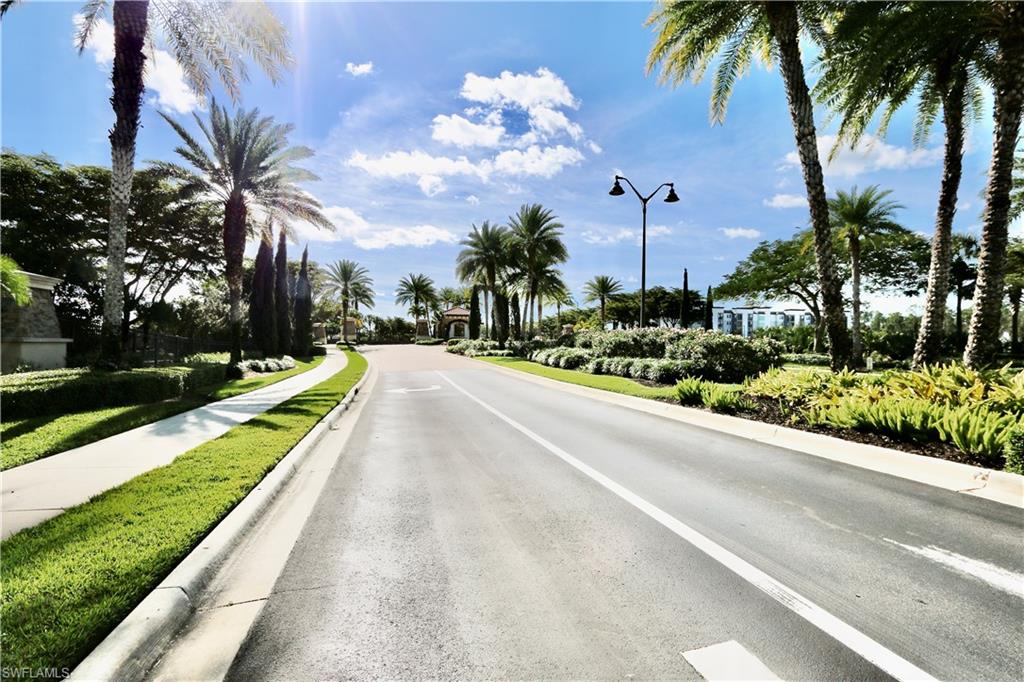 8191 Lucello Terrace North Naples, FL 34114 - Photo 41 of 42 View of asphalt road featuring street lighting, sidewalks, and curbs