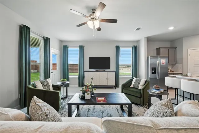 a living room with furniture and a kitchen view