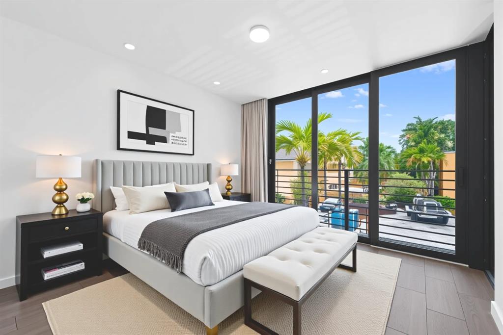 722 Northeast 15th Avenue, Unit 2 Fort Lauderdale, FL 33304 - Photo 12 of 27 a bedroom with a large bed and a large window