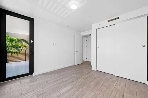 a view of hallway with a large window and wooden floor