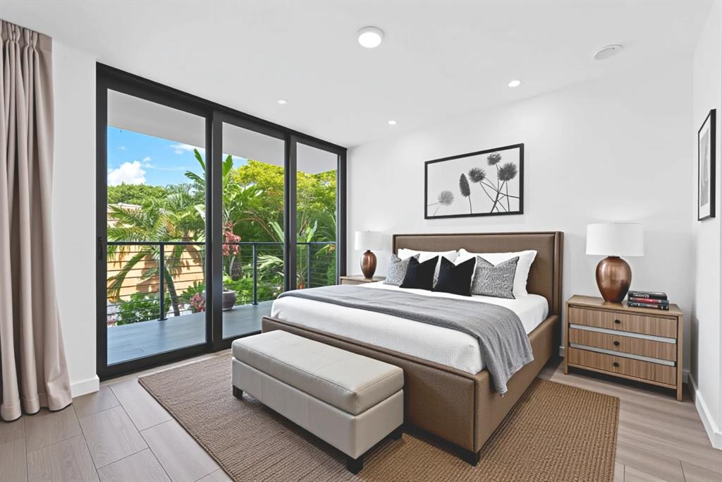 722 Northeast 15th Avenue, Unit 2 Fort Lauderdale, FL 33304 - Photo 16 of 27 a spacious bedroom with a large bed and a large window