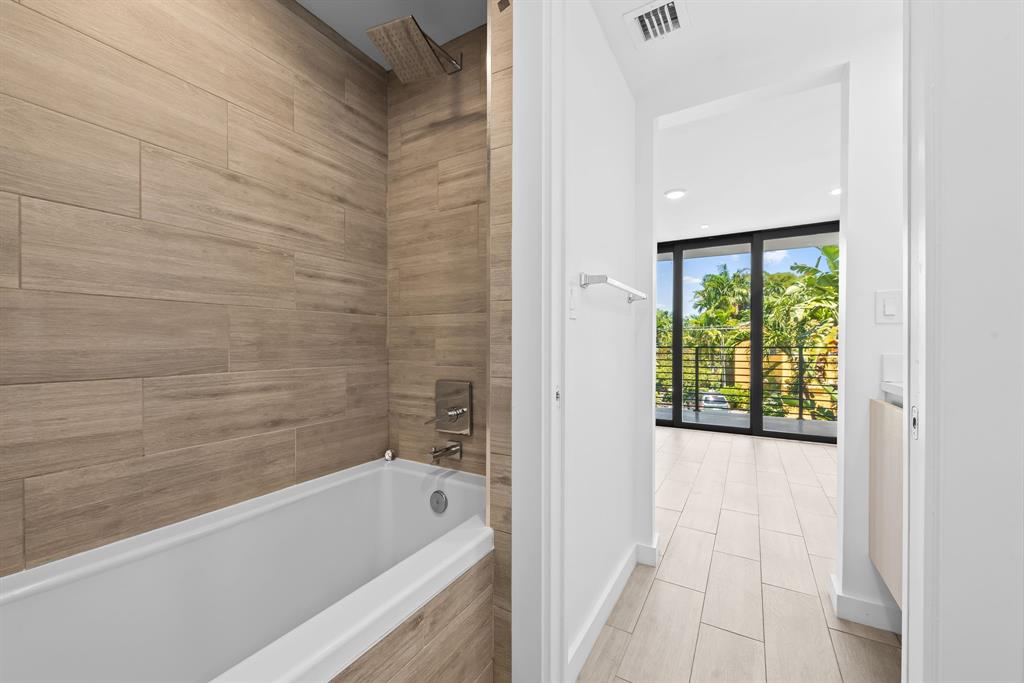 722 Northeast 15th Avenue, Unit 2 Fort Lauderdale, FL 33304 - Photo 18 of 27 a bathroom with a bathtub and a shower
