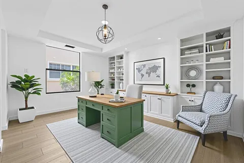 a view of a livingroom with furniture window and wooden floor