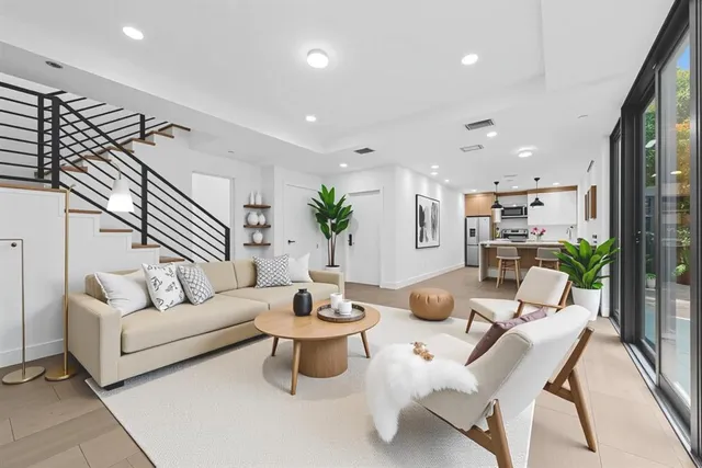 a living room with furniture and wooden floor