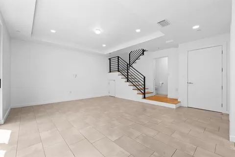 a view of an empty room with stairs