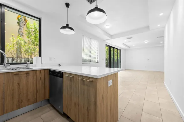 a kitchen with a cabinets and chandelier