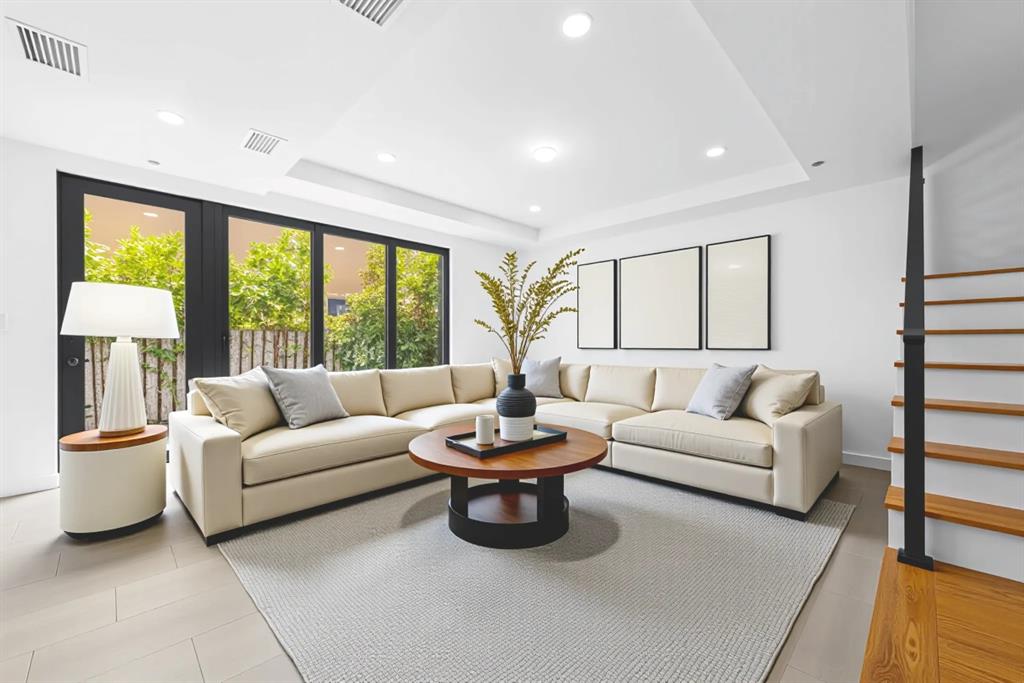 722 Northeast 15th Avenue, Unit 2 Fort Lauderdale, FL 33304 - Photo 3 of 27 a living room with furniture and a large window
