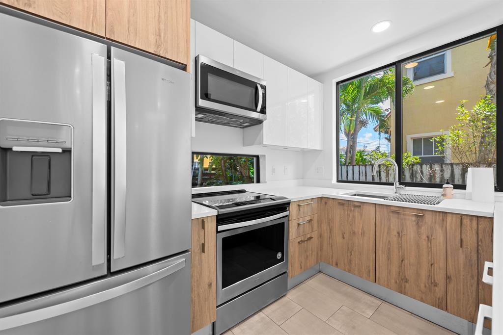 722 Northeast 15th Avenue, Unit 2 Fort Lauderdale, FL 33304 - Photo 4 of 27 a kitchen with a stove top oven and sink