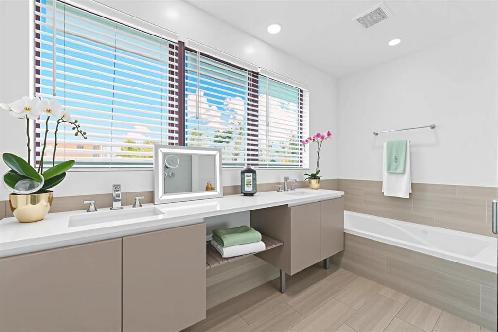 722 Northeast 15th Avenue, Unit 2 Fort Lauderdale, FL 33304 - Photo 9 of 27 a bathroom with a tub a sink and a large mirror