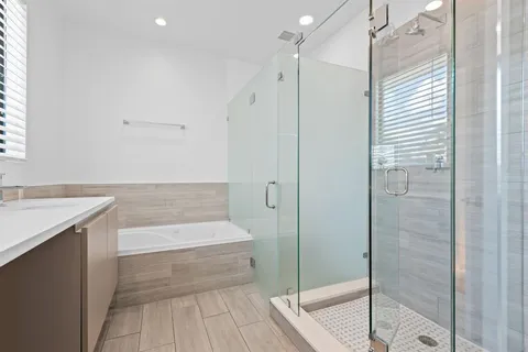 a bathroom with a bathtub and a shower