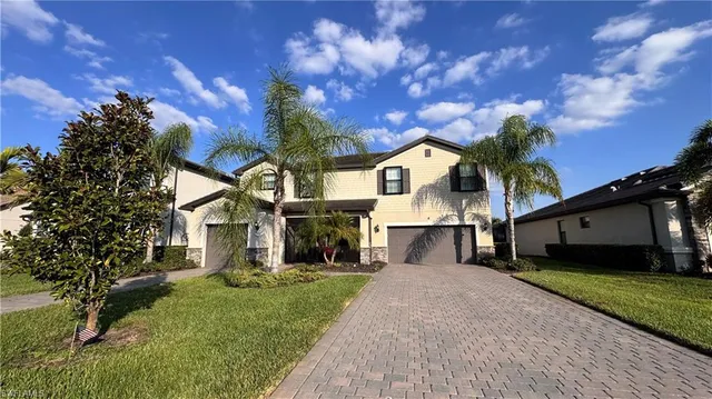 a front view of a house with a yard and garage