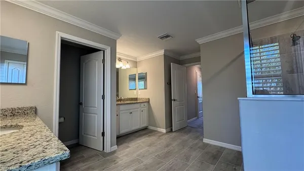 a view of hallway with stairs and a window