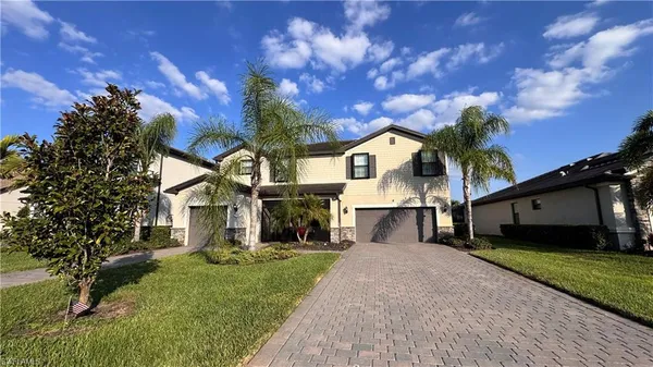 a front view of a house with a yard and garage