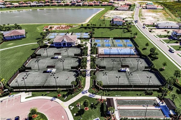 an aerial view of a house with a garden and lake view