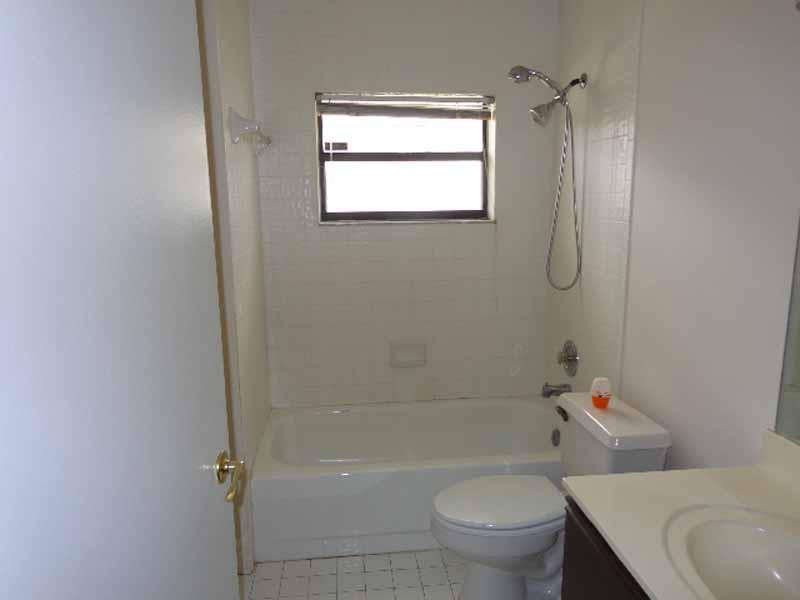 22565 Blue Fin Trail Boca Raton, FL 33428 - Photo 8 of 14 a white toilet sitting next to a bath tub