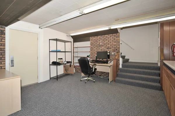 a street view with couple of cars parked on road