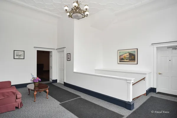 a living room with furniture and a chandelier