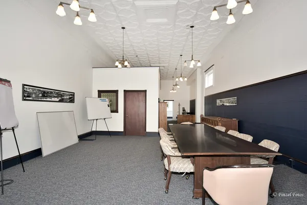 a kitchen with kitchen island a stove a table and chairs